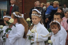 Dzieci pierwszokomunijne witały obraz kwiatami