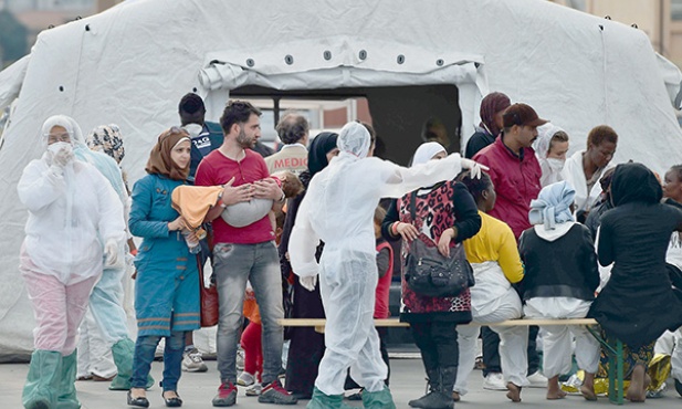 20.10. 2014. Palermo. Włochy. Do portu w Palermo dotarła kolejna grupa imigrantów uratowanych przez straż przybrzeżną. Czerwony Krzyż i katolicka Caritas zorganizowały dla nich pomoc.