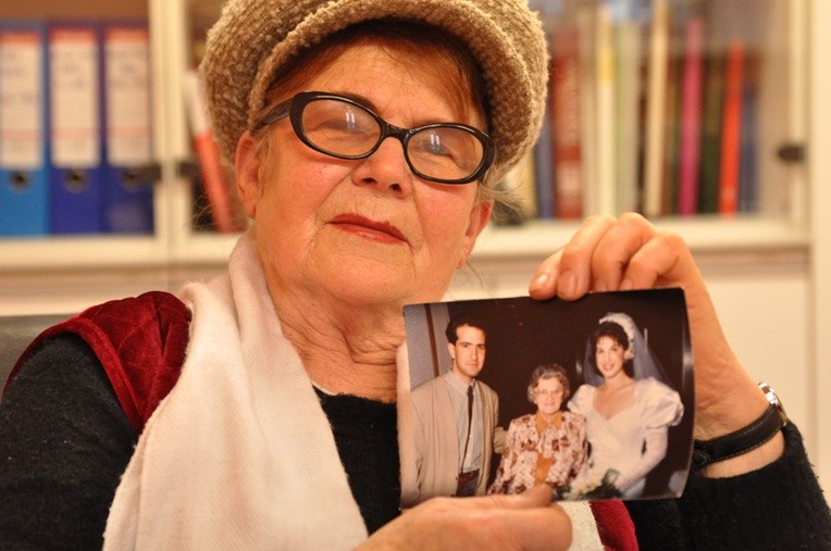 Pani Leokadia Dymańska trzyma zdjęcie Gani z jej synem i synową