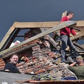 Ekipa z Czarnego przy rozbiórce zniszczonego przez wichurę domu w Żabnie. Ks. Paweł Byczkowski (pierwszy z lewej na dole).