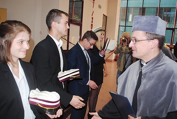 Ks. dr Bartłomiej Krzos gratuluje nowym studentom.