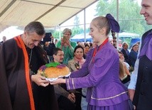 Bp Roman Pindel przyjmuje chleb z tegorocznych plonów z rąk młodych z zespołu "Ziemia Beskidzka"