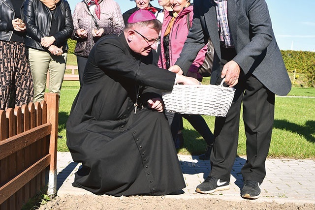Bp Krzysztof Zadarko wraz z innymi gośćmi sadził żonkile,  które wiosną trafią  do darczyńców.