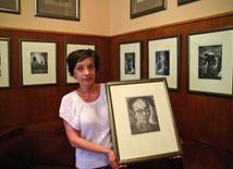  Dorota Rogoż z Muzeum Historii Katowic z autoportretem Pawła Stellera; w tle jego grafiki o śląskiej tematyce
