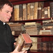 Ks. dr Grzegorz Klaja  przy starych księgach przekazanych muzeum w depozyt 