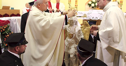 Bp Andrzej F. Dziuba nakłada koronę na figurę św. Michała Archanioła