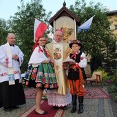 Bp Józef Zawitkowski i ks. Adam Domański oraz dzieci w strojach łowickich przy kapliczce Matki Bożej Księżnej Łowickiej