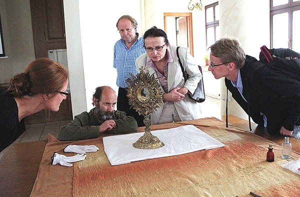 Uczestnicy spotkania muzealnego przyglądają się hałcnowskiej monstrancji z XIX wieku