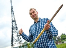 Radosław Daniewicz pokazuje ogromną śrubę – element konstrukcji radiostacji
