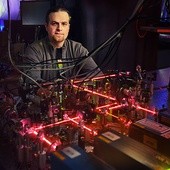 Radosław Chrapkiewicz jest doktorantem Wydziału Fizyki Uniwersytetu Warszawskiego i współautorem tego układu atomowej pamięci kwantowej. Co to takiego? W największym skrócie krótkotrwała pamięć, w której widoczne wiązki lasera mają podobną funkcję do igły magnetycznej w twardym dysku komputera