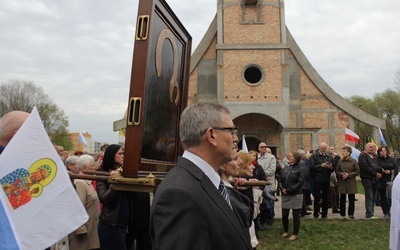 Procesja z obrazem Matki Bożej zmierza do starego kościoła, mijając budującą się świątynię