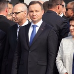 A. Duda i B. Szydło składają kwiaty pod bramą nr 2