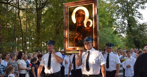 Strażacy niosą jasnogórską ikonę w procesji do kościoła w Jesionce