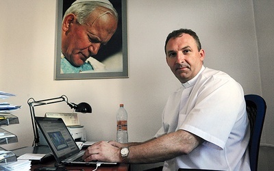 ▲	Ks. Dariusz Kowalczyk w biurze fundacji w Warszawie.