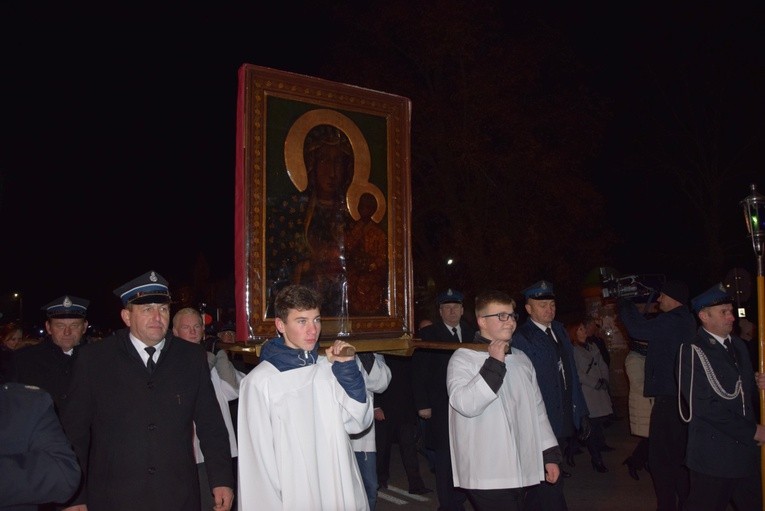 Ministranci niosą ikonę Matki Bożej do kościoła w Regnowie