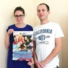 Ula Skotny i Paweł Kuś z plakatem informującym o zbiórce artykułów szkolnych potrzebnych na Syberii.