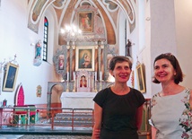 Kinga Swoboda i Katarzyna Strzałkowska ze Stowarzyszenia Dziedzictwo na tle prezbiterium udostępnionej  do zwiedzania świątyni.