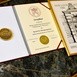Dokumenty i medal, które otrzymał biskup na 50-lecie PWT we Wrocławiu.