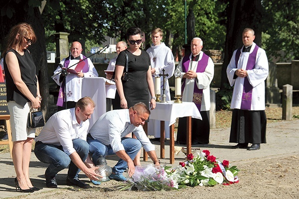 W miejscu nowej mogiły złożono kwiaty i zapalono znicze.