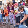 ▲	Dzieci podczas próby bicia rekordu w przenoszeniu wody rękami.