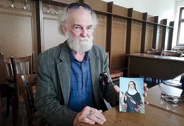 Bogusław Maria Boba Colin z fotografią obrazu św. Rity, namalowanego przez niego dla kościoła w Cygańskim Lesie.
