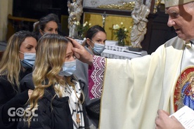 Biskup w czasie udzielania sakramentu bierzmowania jednej z przybyłych osób.