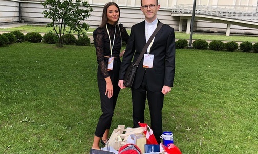 Julia z ks. opiekunem i nagrodami.