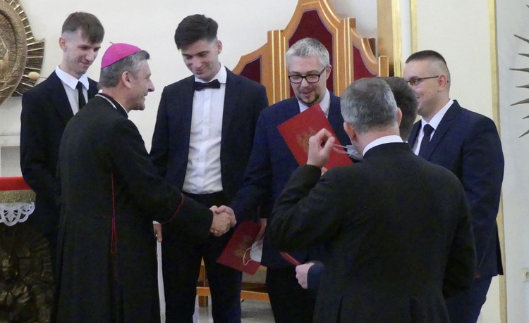 Alumni z bp. Romanem Pindlem w kaplicy kurialnej.