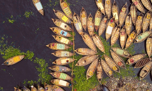 Widok z lotu ptaka na setki łodzi kołyszących się na rzece Buriganga i przypominających do złudzenia płatki kwiatów.
20.04.2022 Dhaka, Bangladesz 