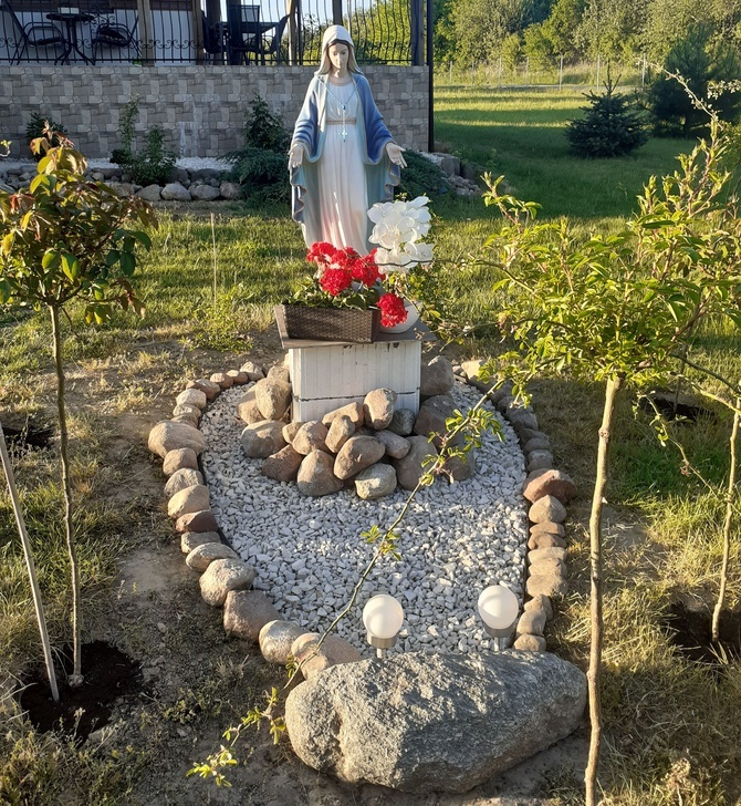 Czerwińsk n. Wisłą. Figura Matki Bożej w przydomowym ogrodzie, przywieziona z Medjugoria, wokół niej kamienie ułożone w 5 tajemnic Różańca