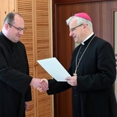 Ks. Krzysztof Iskra odbierający dekret od bp. Marka Mendyka.