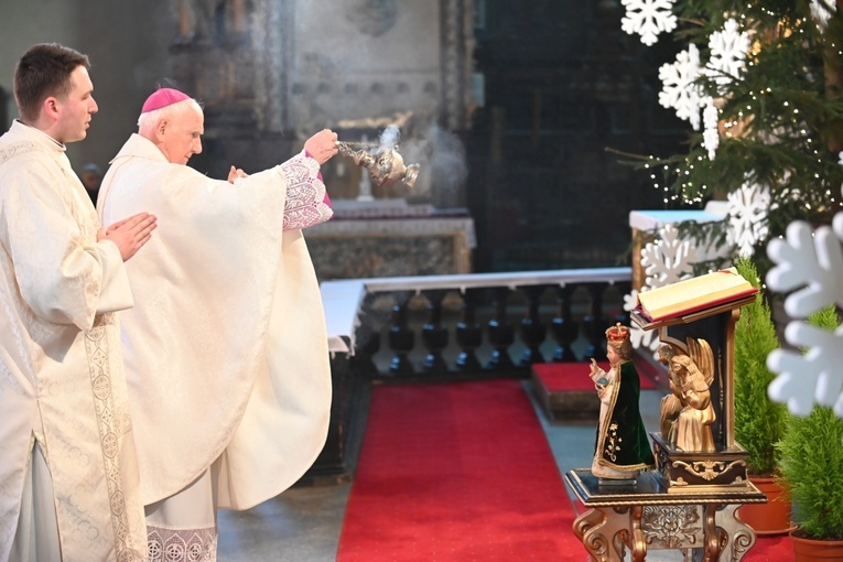 Bp Ignacy Dec okadzający figurę Dzieciątka Jezus.