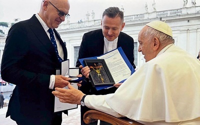 Rektor Sławomir Bukowski i ks. Grzegorz Zieliński wręczyli medal i obraz wykonany na Wydziale Sztuki UTH.