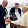 Rektor Sławomir Bukowski i ks. Grzegorz Zieliński wręczyli medal i obraz wykonany na Wydziale Sztuki UTH.