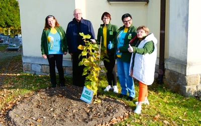 Ks. proboszcz Antoni Dewor z pomagającymi chorym przy nowej żonkilowej rabatce.