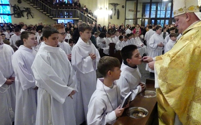 Biskup Piotr Greger wraz z innymi kapłanami wręczał krzyże lektorskie i księgi Pisma Świętego.