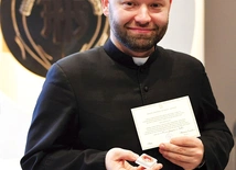 	Ksiądz Damian Drop prezentuje relikwie.