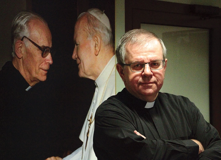 Ks. Grzegorz przy zdjęciu Jana Pawła II – to jego kazanie poruszyło serca ludzi biznesu.