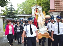 Strażacy wnoszą figurę świętego.