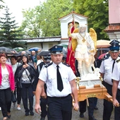 Strażacy wnoszą figurę świętego.