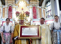 Bp Roman Pindel i ks. kustosz Sebastian Rucki prezentują nowy dekret.